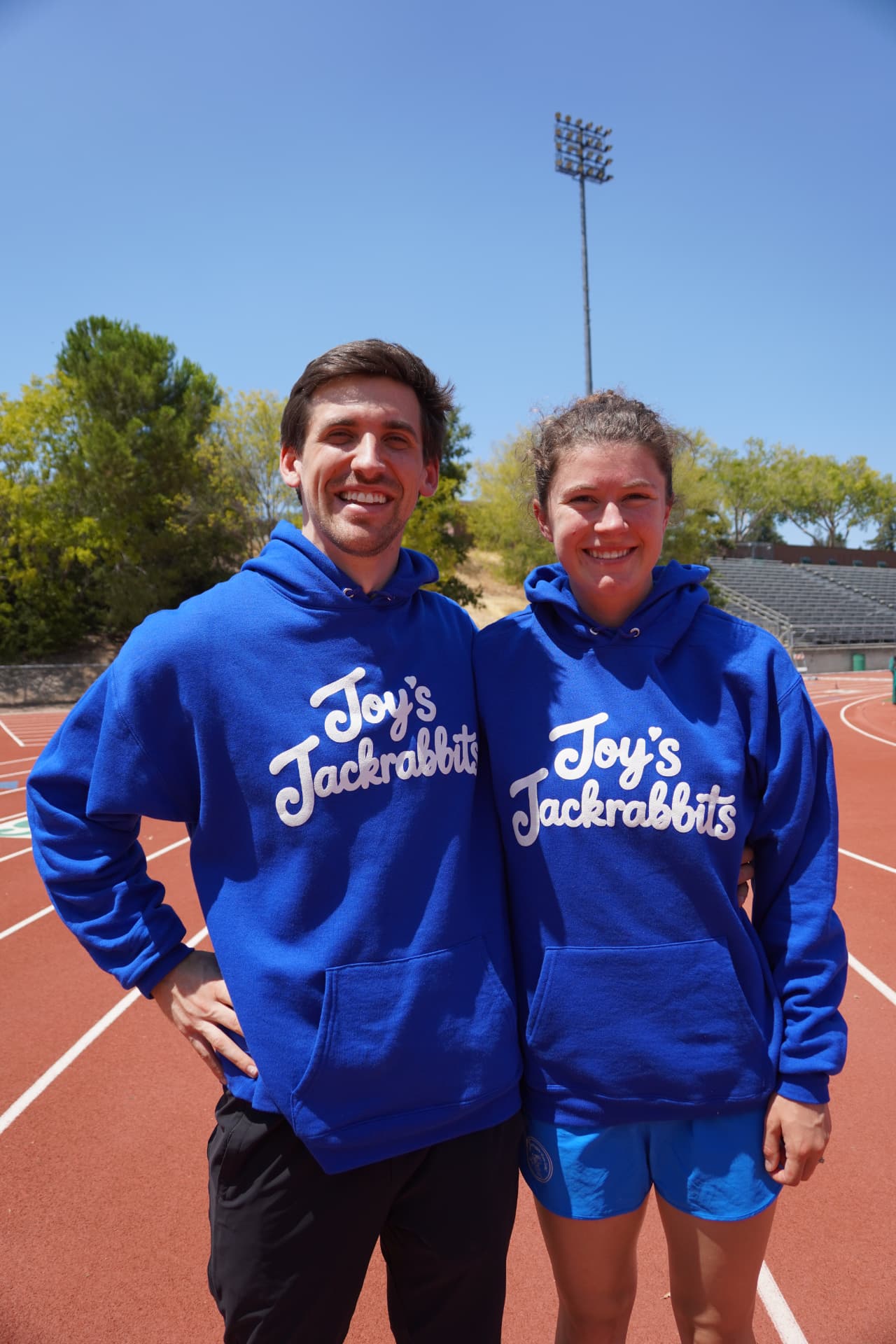 Two people wearing matching Jackrabbits hoodies
