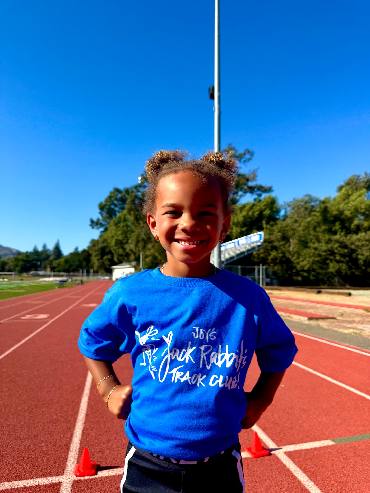 Young runner wearing the Joy's Jackrabbits pilot collection T-shirt on the track